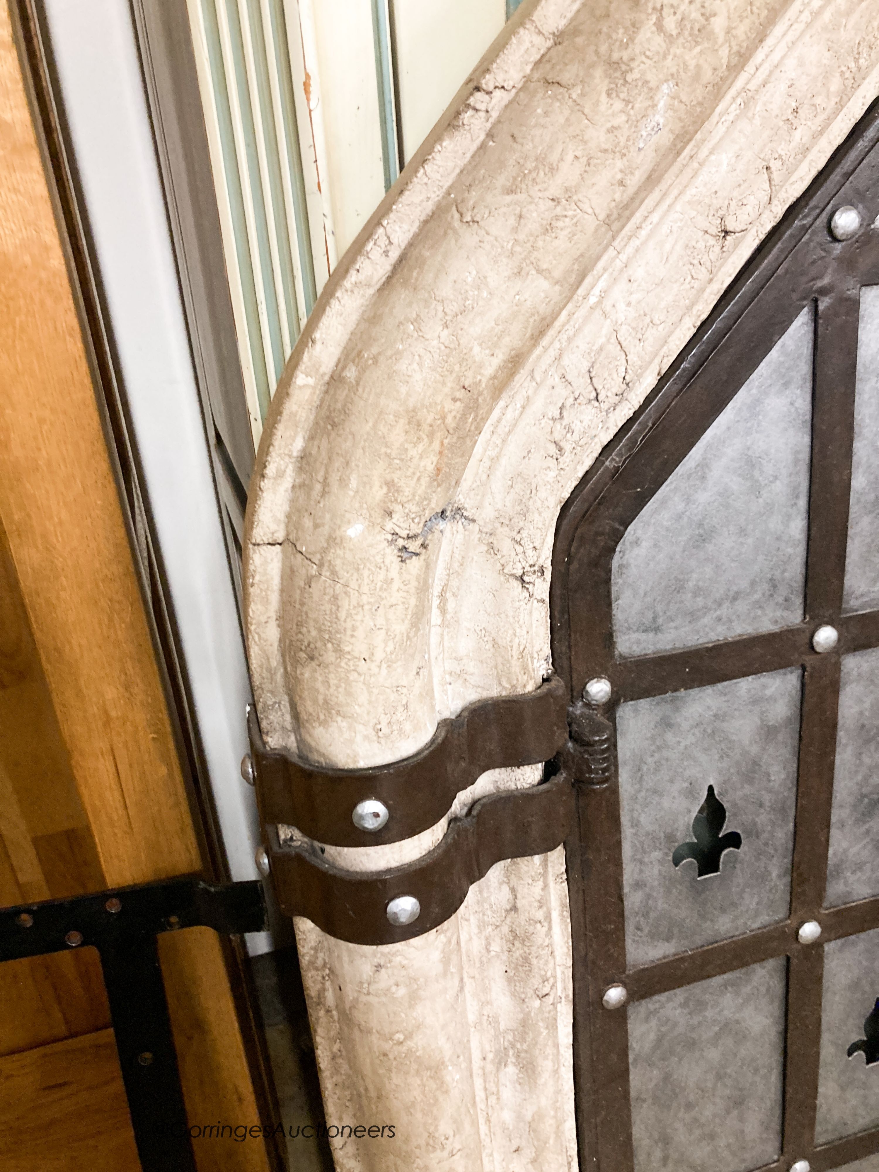 A medieval style simulated stone and wrought iron wall mirror, width 92cm, height 156cm